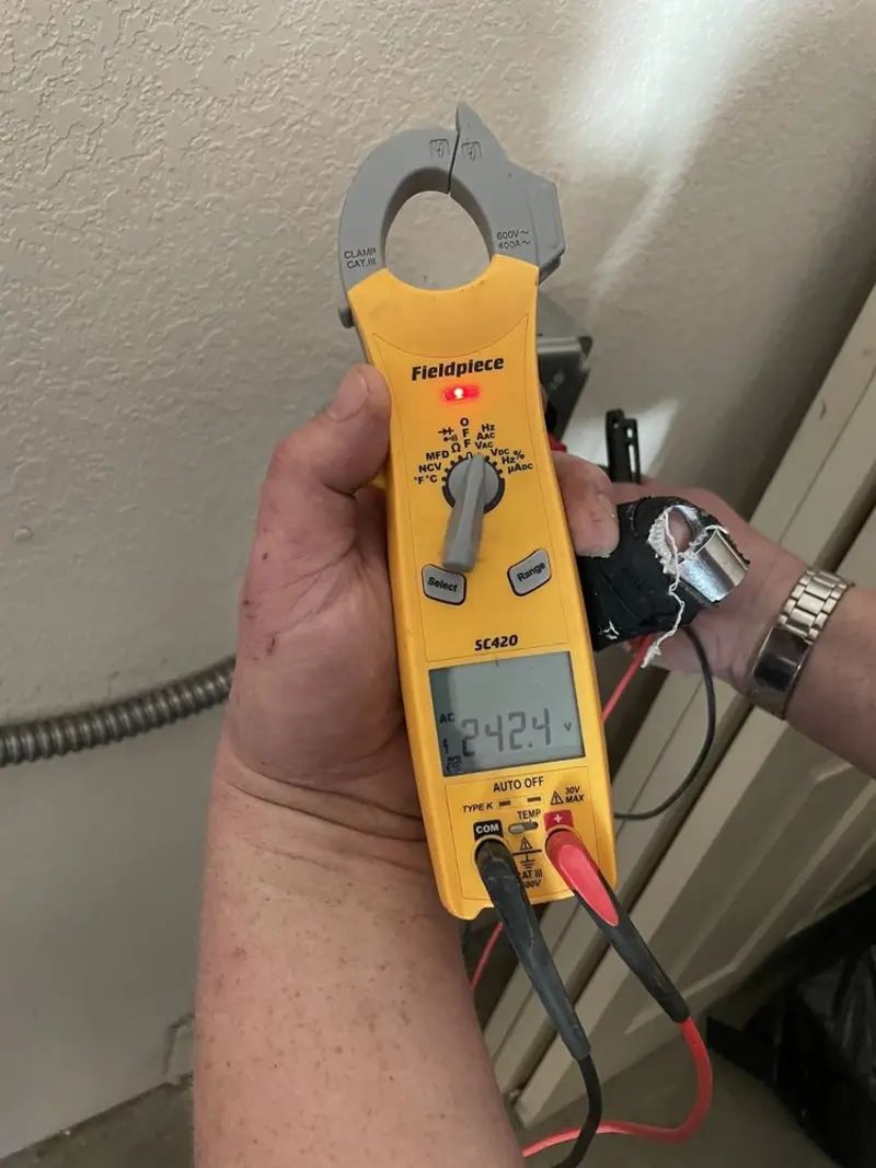 Voltage testing with clamp meter during Electrical Installation Services in Lake of the Woods